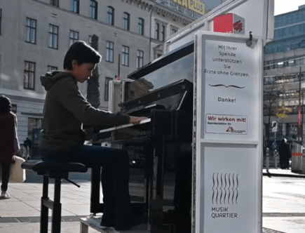 Ein Bub spielt mitten auf der wiener Mariahilferstraße ein Klavier - das Pianomobil